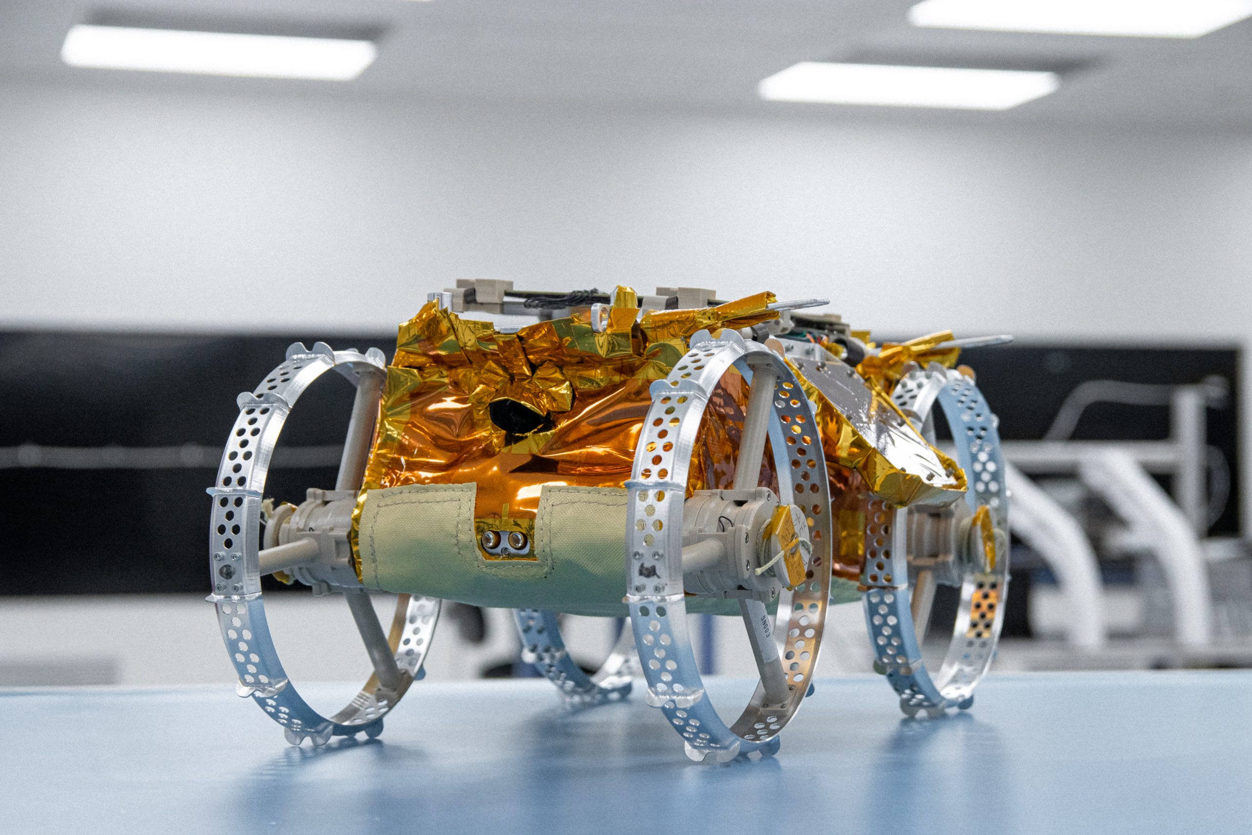 A lunar rover sits in a lab ready for the Moon.